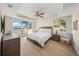 Bright bedroom with water views and private balcony access at 166 Golden Gate Pt # 21, Sarasota, FL 34236