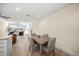 Bright dining area with wood table and four chairs, adjacent to kitchen at 166 Golden Gate Pt # 21, Sarasota, FL 34236