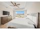 Main bedroom with king-size bed and stunning water views at 166 Golden Gate Pt # 21, Sarasota, FL 34236