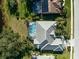 House with tile roof, pool, and landscaped yard, viewed from above at 2008 Tocobaga Ln, Nokomis, FL 34275