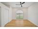 Bright bedroom with wood floors and arched window at 2008 Tocobaga Ln, Nokomis, FL 34275