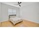 Bright bedroom with light wood floors and ceiling fan at 2008 Tocobaga Ln, Nokomis, FL 34275