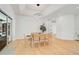 Light-filled dining area with hardwood floors and modern light fixture at 2008 Tocobaga Ln, Nokomis, FL 34275