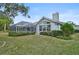 House back view showcasing the pool and landscaped yard at 2008 Tocobaga Ln, Nokomis, FL 34275