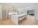 Modern kitchen with large island, stainless steel appliances, and light wood cabinets at 2008 Tocobaga Ln, Nokomis, FL 34275