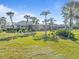 Home with a large backyard, tropical landscaping, and screened enclosure at 2115 Calusa Lakes Blvd, Nokomis, FL 34275