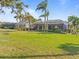 Spacious backyard with grassy lawn and screened patio at 2115 Calusa Lakes Blvd, Nokomis, FL 34275