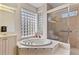 Spa-like bathroom featuring a soaking tub and walk-in shower at 2115 Calusa Lakes Blvd, Nokomis, FL 34275