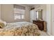 Bedroom with floral bedding and a wooden dresser at 2115 Calusa Lakes Blvd, Nokomis, FL 34275