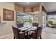 Breakfast nook with glass table and chairs overlooking the pool and golf course at 2115 Calusa Lakes Blvd, Nokomis, FL 34275