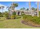 House exterior showcasing a three-car garage and manicured lawn at 2115 Calusa Lakes Blvd, Nokomis, FL 34275