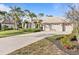 Exterior of house with a three-car garage and a paved driveway at 2115 Calusa Lakes Blvd, Nokomis, FL 34275