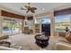 Living room with ample seating, large windows, and sliding doors leading to the pool area at 2115 Calusa Lakes Blvd, Nokomis, FL 34275