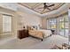 Main bedroom with tray ceiling, ample natural light, and access to the pool area at 2115 Calusa Lakes Blvd, Nokomis, FL 34275