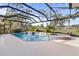 Relax in your own backyard oasis featuring a screened pool and spa at 2115 Calusa Lakes Blvd, Nokomis, FL 34275