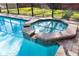 Octagonal spa with waterfall feature at 2232 Elcid Ct, Palm Harbor, FL 34683