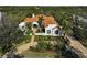 Spanish-style home with manicured landscaping and a gated entrance at 230 Osprey Point Dr, Osprey, FL 34229