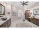 Elegant bathroom with double sinks, large mirror and custom cabinetry at 230 Osprey Point Dr, Osprey, FL 34229