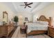 Spacious main bedroom with wood furniture and large windows at 230 Osprey Point Dr, Osprey, FL 34229