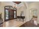 Grand entryway featuring a stunning chandelier and hardwood floors at 230 Osprey Point Dr, Osprey, FL 34229