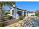 White stucco home with brown garage doors and landscaping at 230 Osprey Point Dr, Osprey, FL 34229