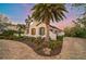 White stucco home with brown accents and lush landscaping at 230 Osprey Point Dr, Osprey, FL 34229