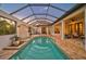 Enclosed pool and spa with covered patio and seating area at 230 Osprey Point Dr, Osprey, FL 34229