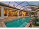 Enclosed pool and patio area with seating and outdoor kitchen at 230 Osprey Point Dr, Osprey, FL 34229