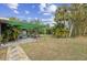 Large backyard with a pergola and lush landscaping at 230 Salisbury St, Port Charlotte, FL 33954