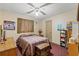 Bedroom with double bed, ceiling fan, and wood dresser at 230 Salisbury St, Port Charlotte, FL 33954