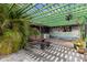 Relaxing pergola patio with brick flooring and hanging plants at 230 Salisbury St, Port Charlotte, FL 33954