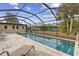 Screened-in pool with lounge chairs and patio area at 230 Salisbury St, Port Charlotte, FL 33954