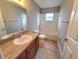 Clean bathroom with tub, toilet and granite vanity at 2309 30Th W Ave, Bradenton, FL 34205