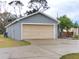 House exterior, featuring a beige garage door and gray walls at 2309 30Th W Ave, Bradenton, FL 34205