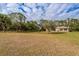 Large backyard with mature trees and open space at 2415 Nowatney Ave, North Port, FL 34286