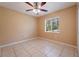 Spacious bedroom with ceiling fan and window at 2415 Nowatney Ave, North Port, FL 34286