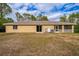 House back view, showing backyard and AC units at 2415 Nowatney Ave, North Port, FL 34286