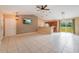 Open living room and kitchen with tile floors and high ceilings at 2415 Nowatney Ave, North Port, FL 34286