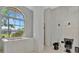 Bathroom with large window, soaking tub and tiled walls at 26071 Paysandu Dr, Punta Gorda, FL 33983