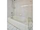 Clean bathroom featuring a bathtub and tiled walls at 26071 Paysandu Dr, Punta Gorda, FL 33983