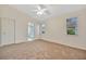 Primary bedroom with carpet, ceiling fan and ensuite bathroom at 26071 Paysandu Dr, Punta Gorda, FL 33983