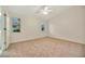 Bright bedroom with neutral carpeting and ceiling fan at 26071 Paysandu Dr, Punta Gorda, FL 33983