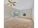 Living room with pool view and ceiling fan at 26071 Paysandu Dr, Punta Gorda, FL 33983