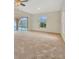 Spacious living room, pool view, and ceiling fan at 26071 Paysandu Dr, Punta Gorda, FL 33983