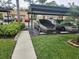 Covered parking area with cars parked underneath at 2657 Woodgate Ln # E4, Sarasota, FL 34231