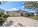 Charming single-Gathering home featuring a spacious driveway, well-manicured lawn, and an inviting facade at 2925 122Nd E Pl, Parrish, FL 34219