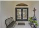 Inviting front porch featuring double doors, a welcome sign, and charming decorative elements at 2925 122Nd E Pl, Parrish, FL 34219