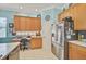 Well-equipped kitchen with stainless steel refrigerator and built in desk area at 2925 122Nd E Pl, Parrish, FL 34219