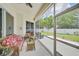 Screened-in patio featuring wicker furniture and an inviting outdoor seating area with a view of the green yard at 2925 122Nd E Pl, Parrish, FL 34219