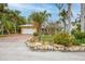 Single-story home with a large garage and attractive landscaping at 306 55Th St, Holmes Beach, FL 34217